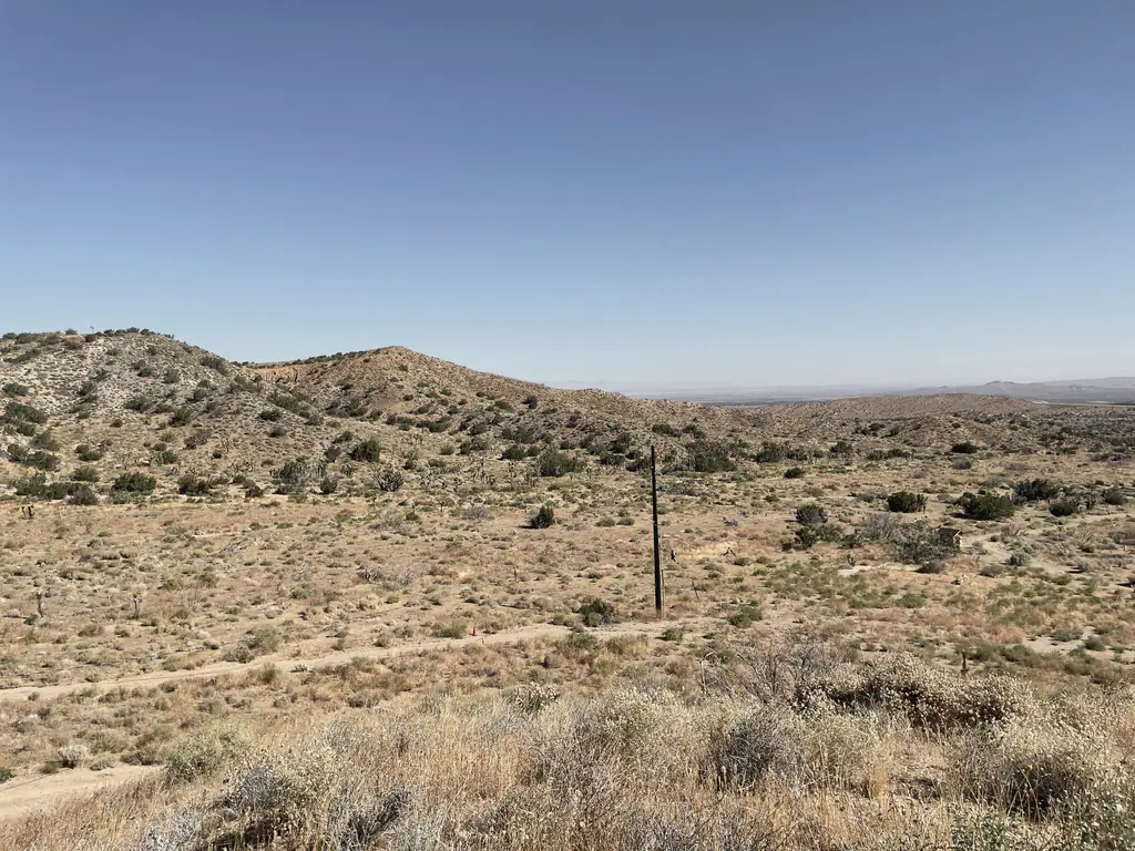 The hills around the property under a clear sky