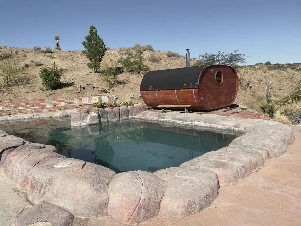 The rock pool with the cedar barrel sauna behind it